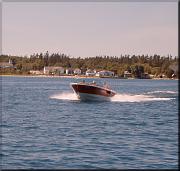 A speedboat emerging from the harbor